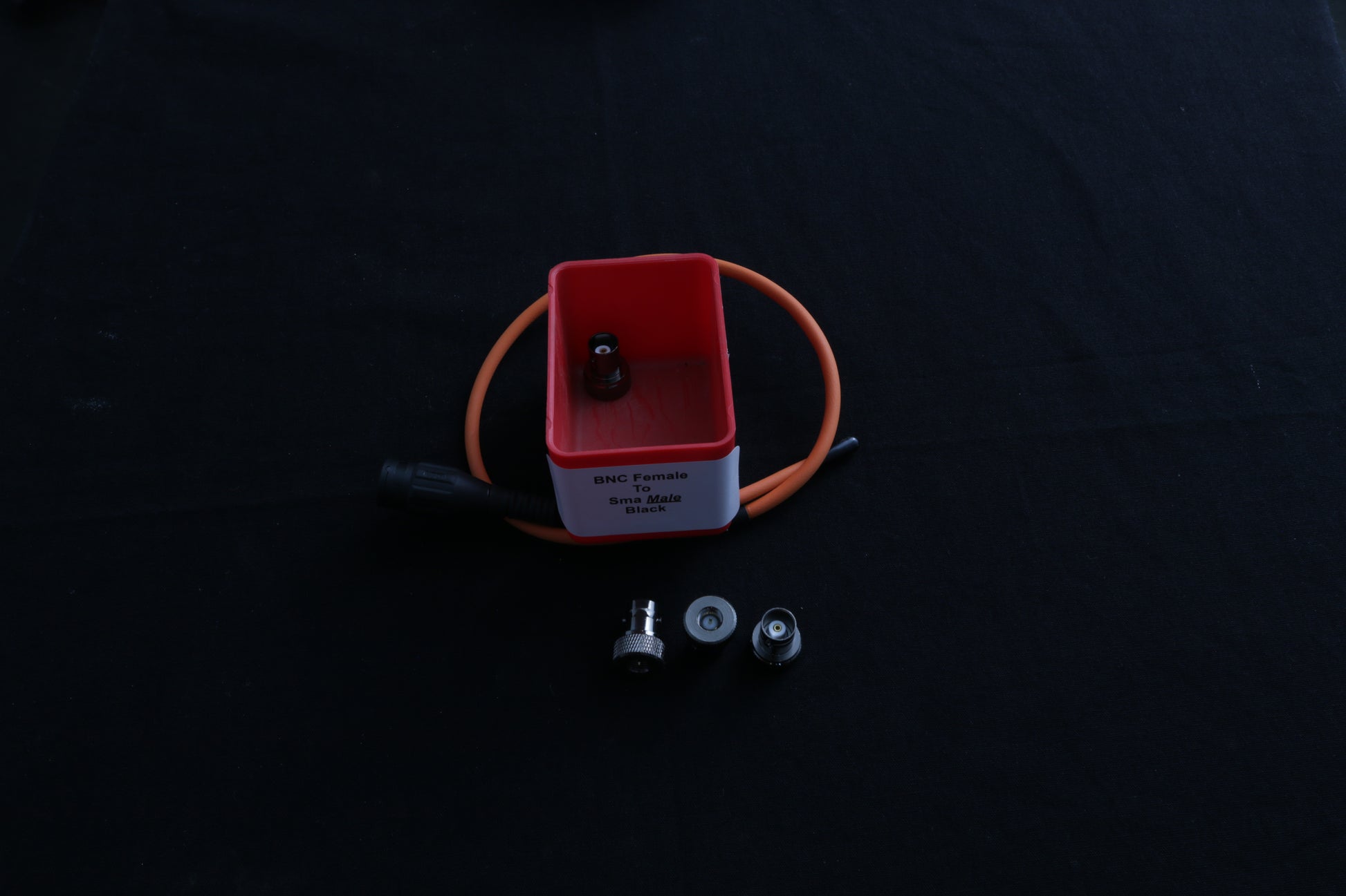 red box with SMA Male to BNC female adapters