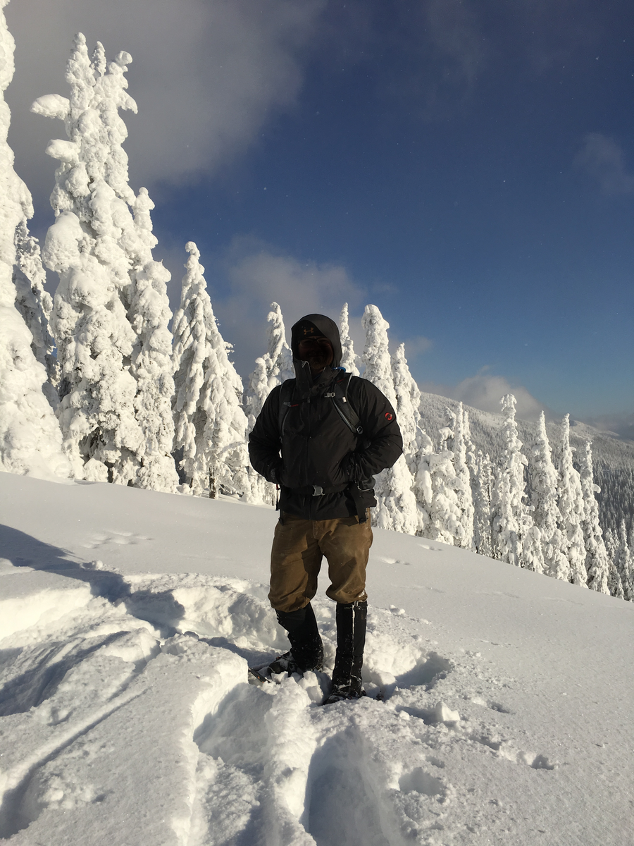 Snowshoer standing on a snowy Idaho summit among frosted trees